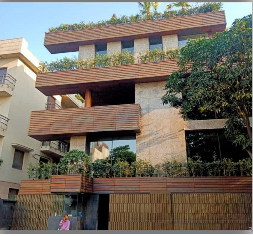Modern home facade with wood-look cladding and planters